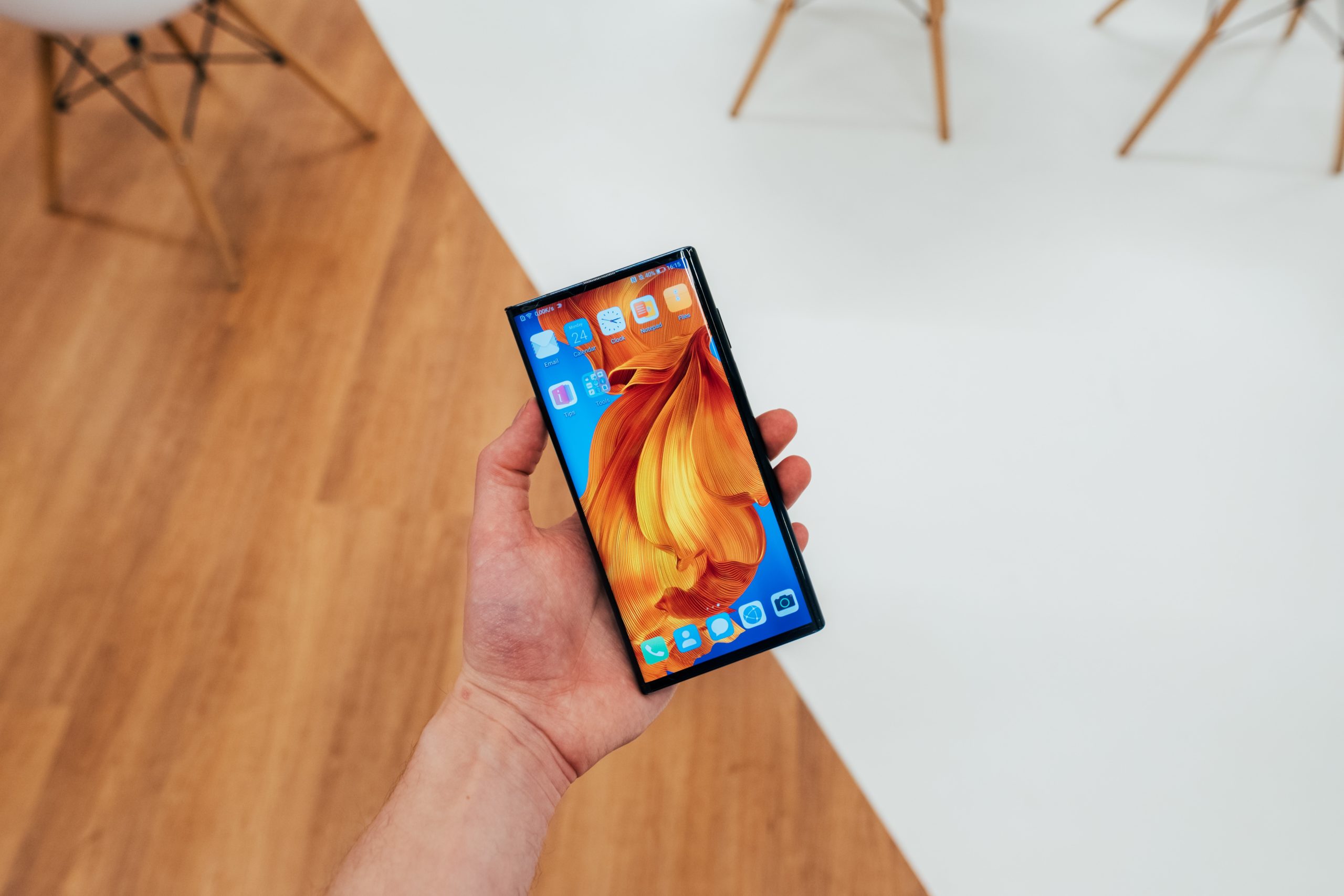 person holding blaHuawei Mate X Headck android smartphone