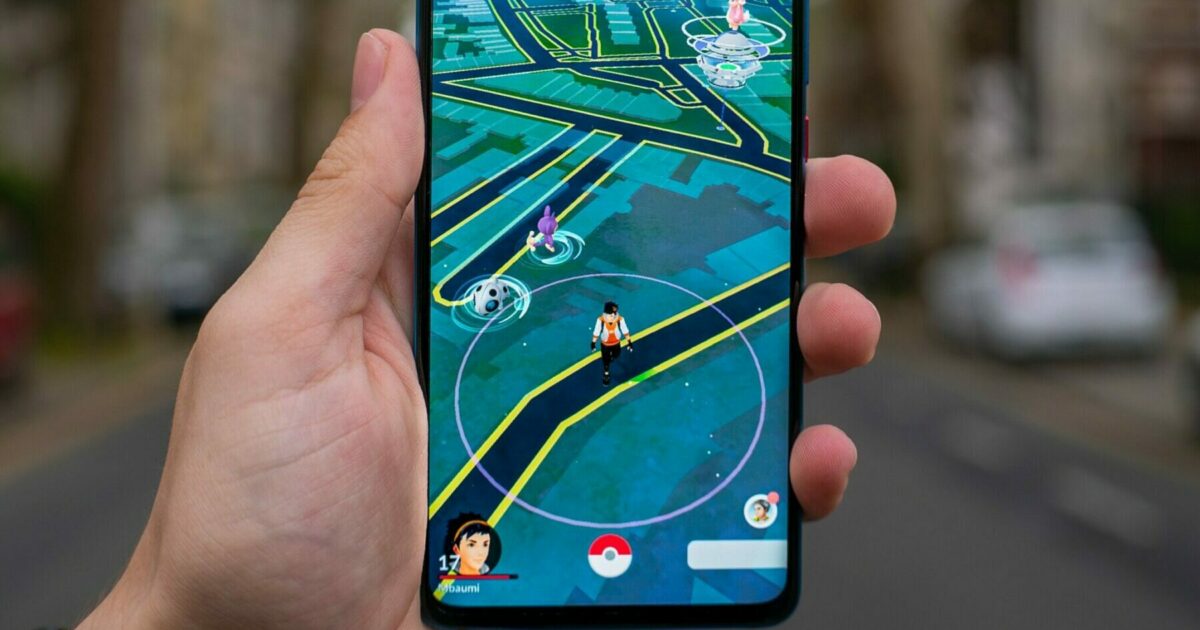 person holding black android smartphone pokemon go